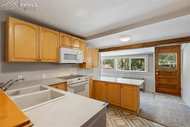 a kitchen with stainless steel appliances a sink and a refrigerator