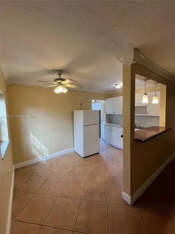 a view of a kitchen with furniture and an empty room