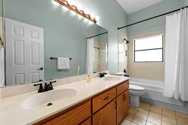 a bathroom with a sink double vanity and a bathtub