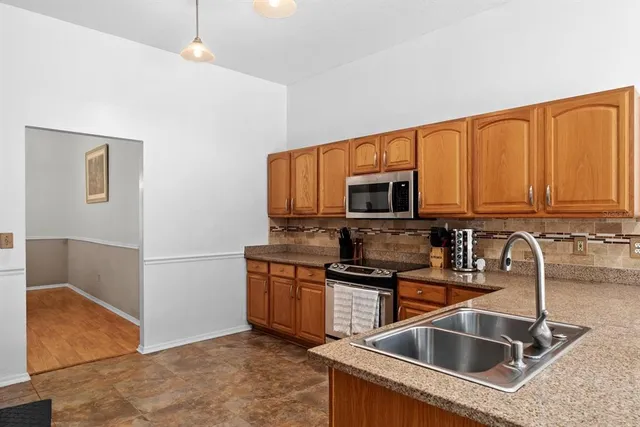 a kitchen that has a sink and a stove top oven