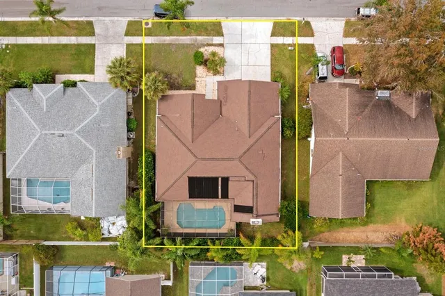 an aerial view of residential houses with outdoor space and street view