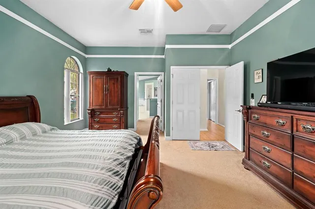 a bedroom with a bed and a flat screen television