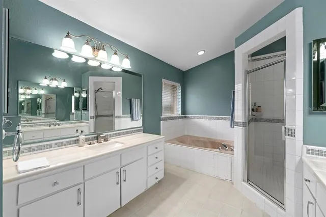 a spacious bathroom with a large tub shower and sink
