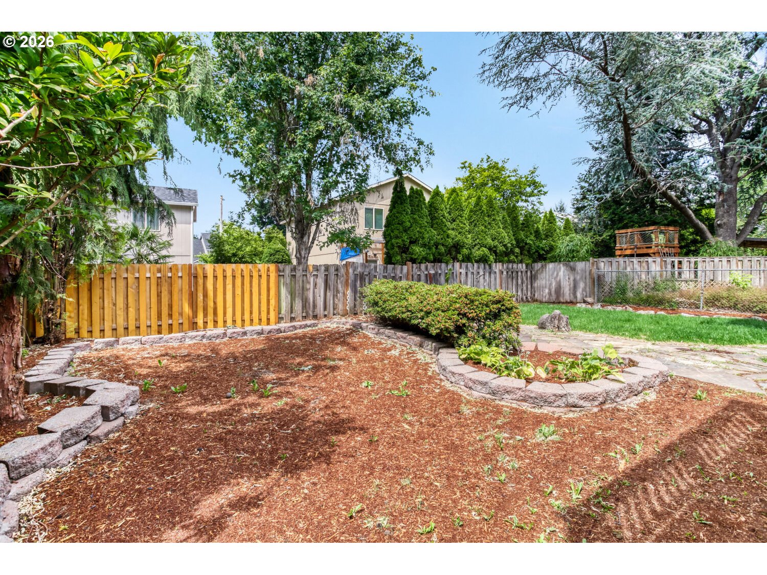 14539 Southeast Center Street Portland, OR 97236 - Photo 27 of 30 a view of a backyard with large tree and wooden fence