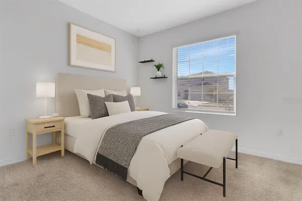 a bedroom with a bed and a window