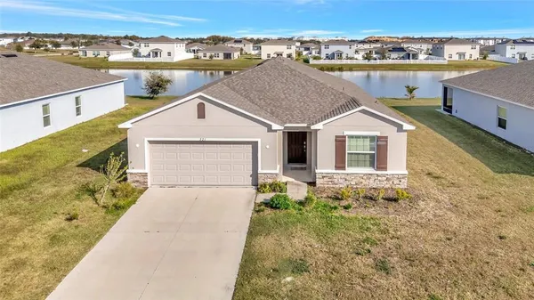 an aerial view of a house with a yard