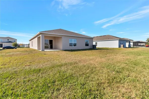 a big house with a big yard and large trees