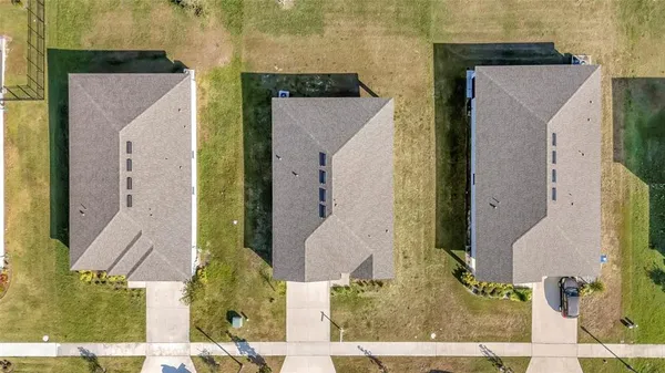 an aerial view of a house with a yard