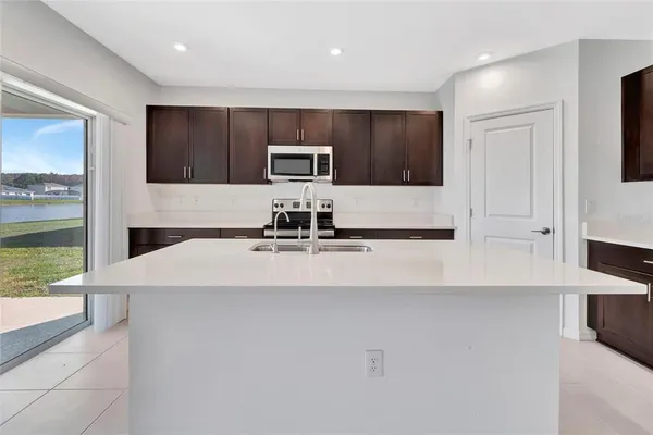 a kitchen with a sink and a refrigerator