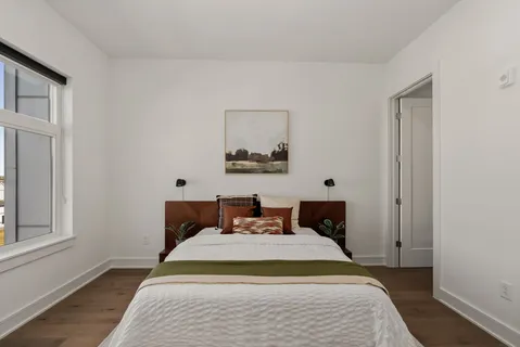 a bedroom with bed and window