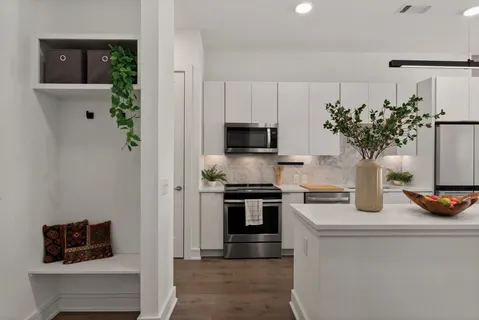 a kitchen with a refrigerator and a stove