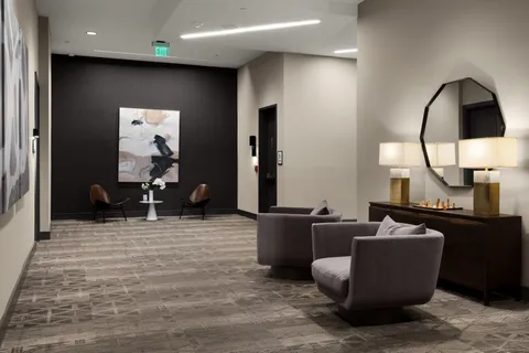 a view of a terrace with furniture and a floor to ceiling window