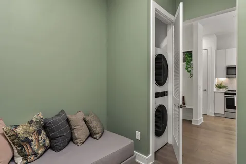 a kitchen with stainless steel appliances a stove a sink a microwave a dining table and chairs