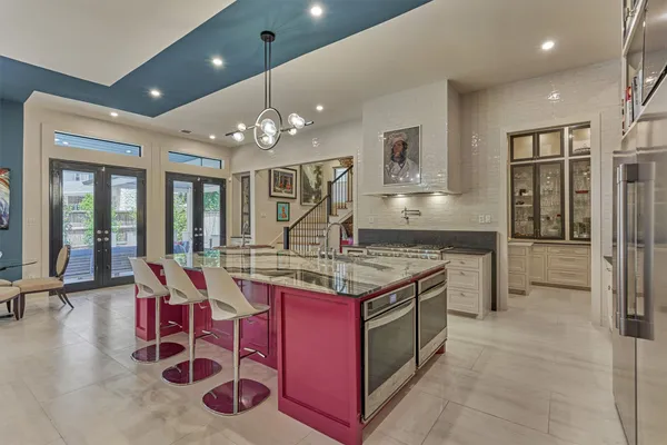 a kitchen with stainless steel appliances granite countertop a stove and a wooden floors