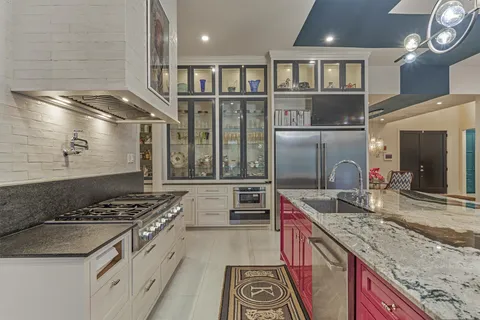 a kitchen with stainless steel appliances granite countertop a stove and a sink