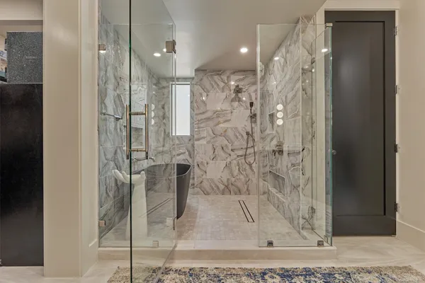a bathroom with a glass shower door
