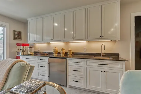 a kitchen with granite countertop a sink and cabinets