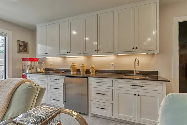 a kitchen with granite countertop a sink and cabinets