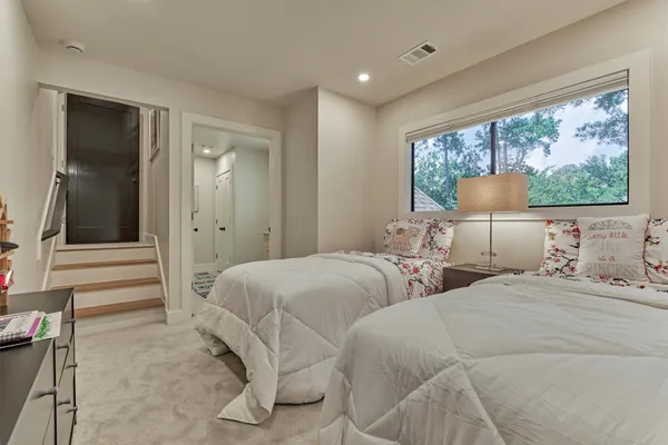 a bedroom with two beds and a large window