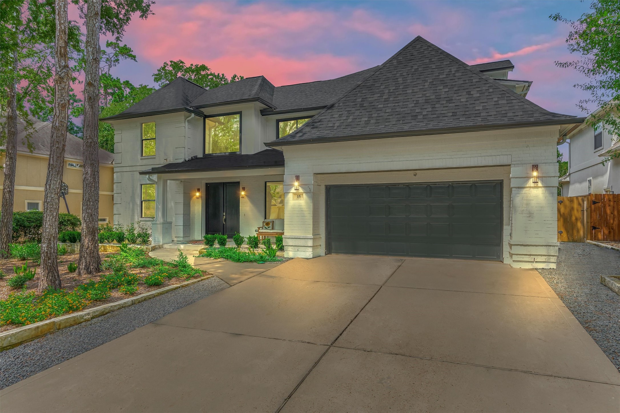 15 Atrium Woods Court The Woodlands, TX 77381 - Photo 4 of 50 a front view of a house with garden