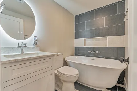 a bathroom with a sink a toilet and a mirror