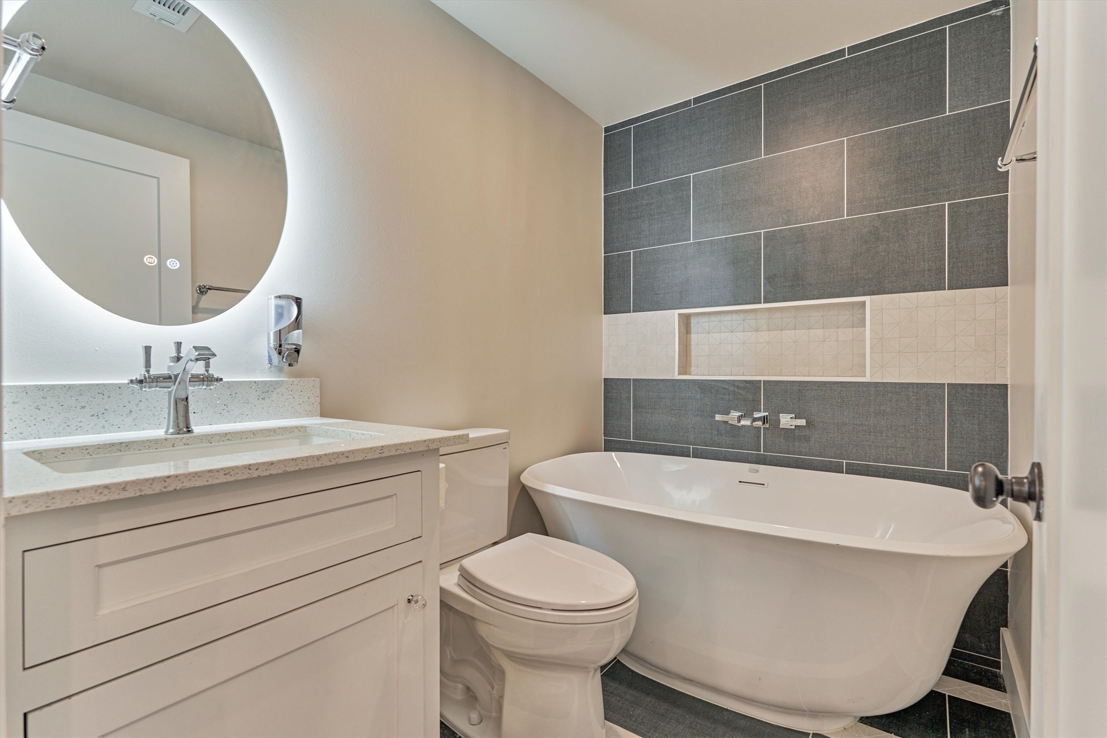 15 Atrium Woods Court The Woodlands, TX 77381 - Photo 44 of 50 a bathroom with a sink a toilet and a mirror