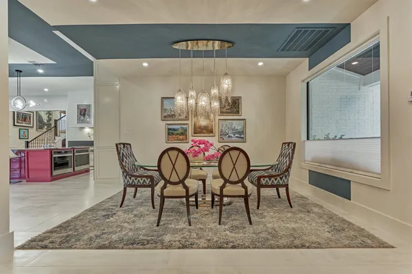 a view of a dining room with furniture and chandelier