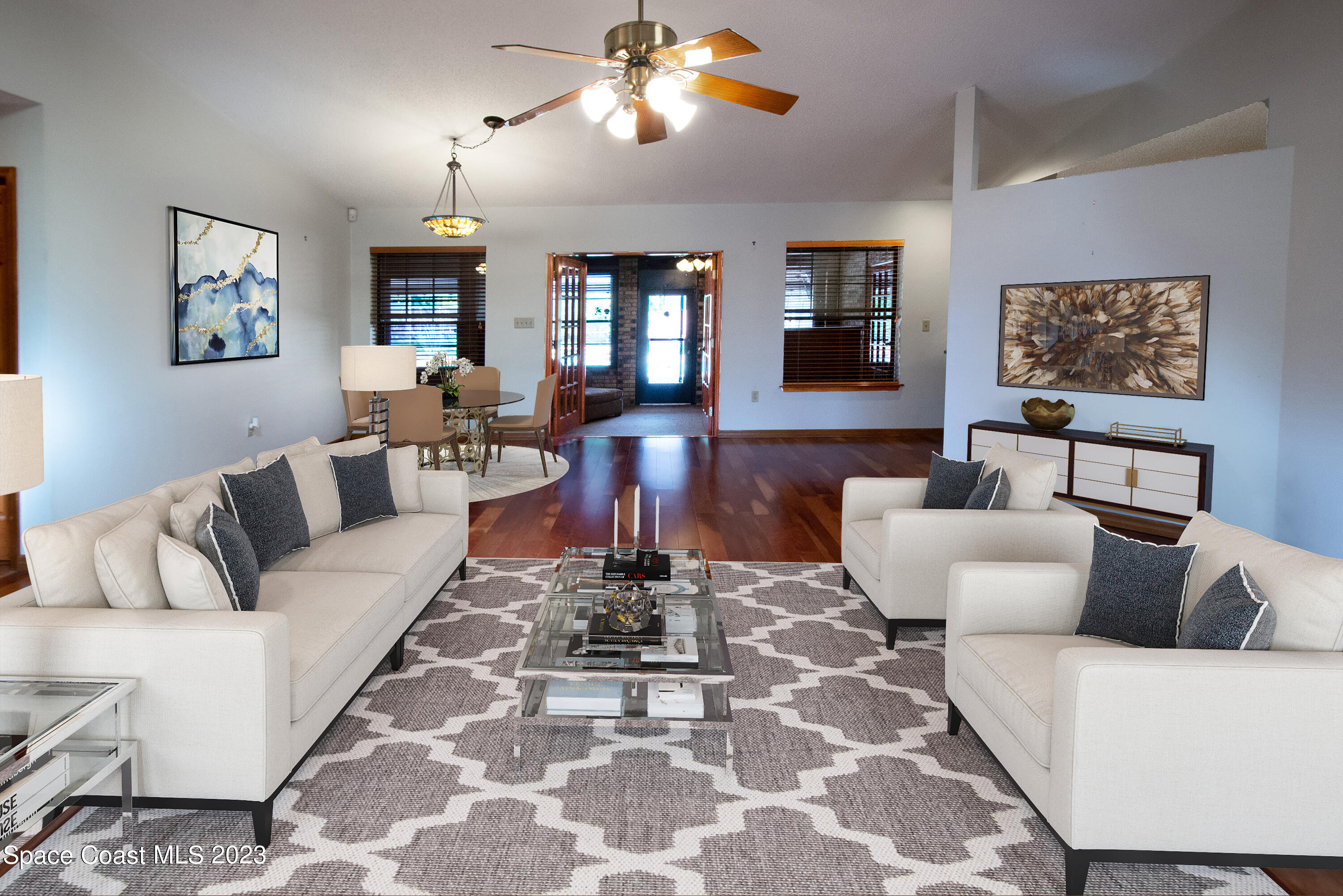 970 Atz Road Malabar, FL 32950 - Photo 8 of 47 a living room with furniture a chandelier and a rug