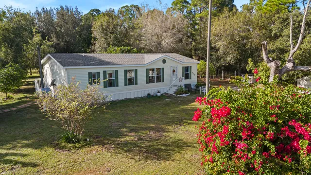 a front view of a house with a yard and fountain