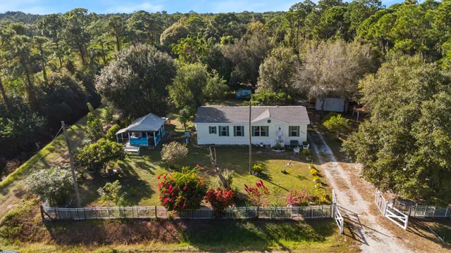 an aerial view of house with yard swimming pool and outdoor seating