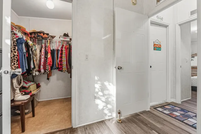 a view of walk in closet with clothes