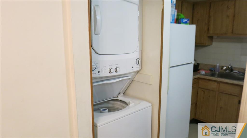 1920 Raspberry Court, Unit 1920 Edison, NJ 08817 - Photo 5 of 12 a utility room with dryer and washer