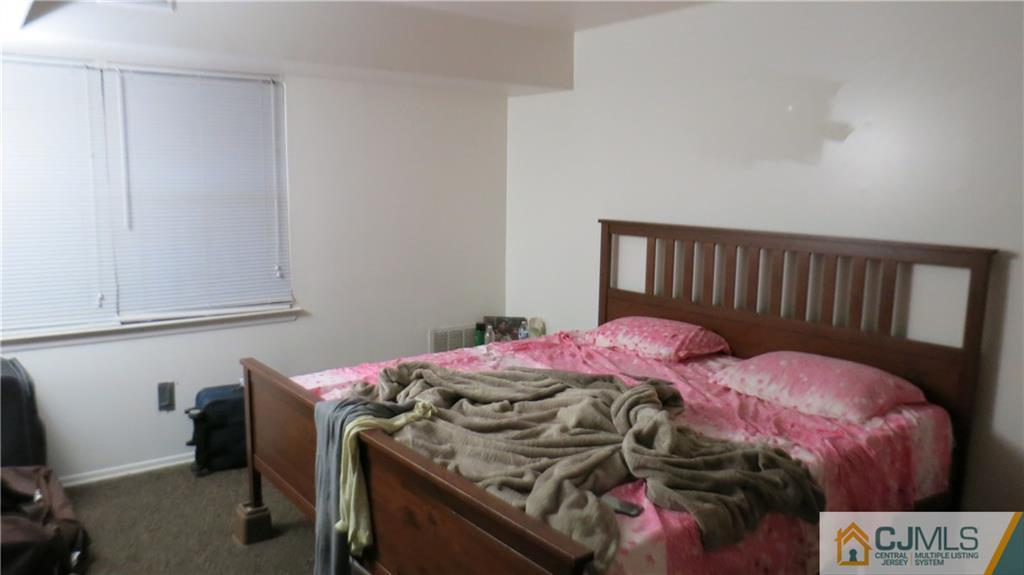 1920 Raspberry Court, Unit 1920 Edison, NJ 08817 - Photo 7 of 12 a bedroom with a bed and a window