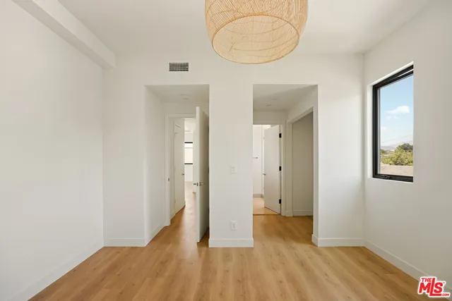 a view of hallway with wooden floor