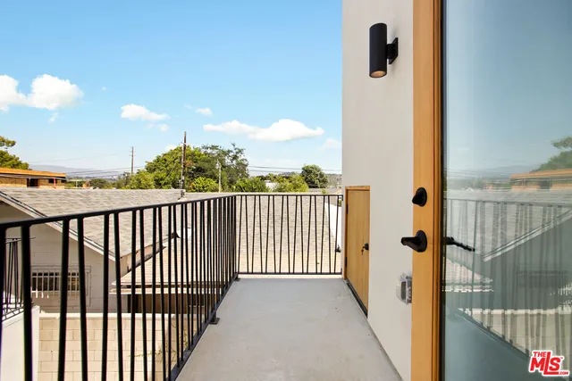 a view of a balcony with wooden fence