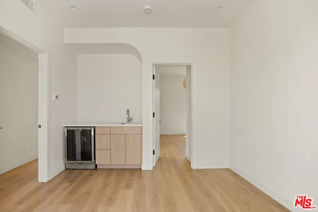 a view of a kitchen with a sink and cabinets