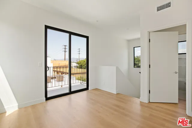 an empty room with windows and closet