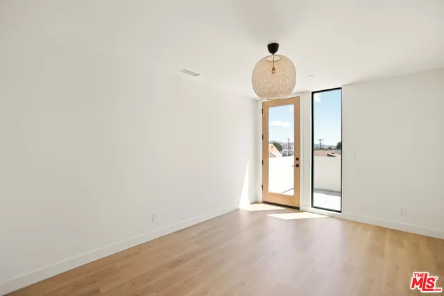a view of a room with wooden floor and window