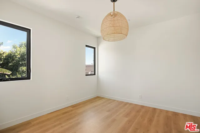 a room with wooden floor and window