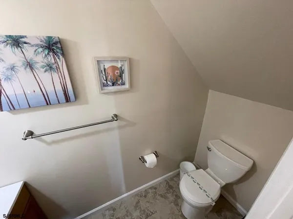 a white toilet sitting next to a shower