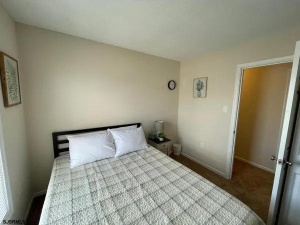 a bedroom with a bed and cupboard