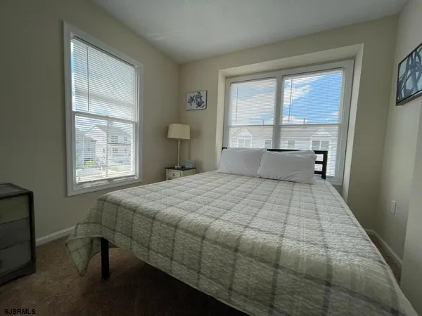 a bedroom with a large bed and a large window