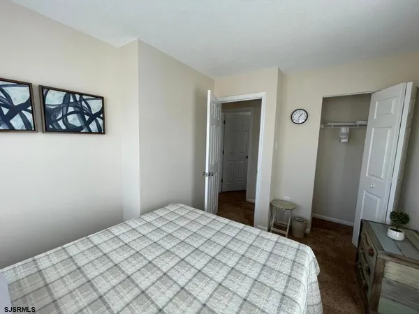 a bedroom with a bed and a flat tv screen