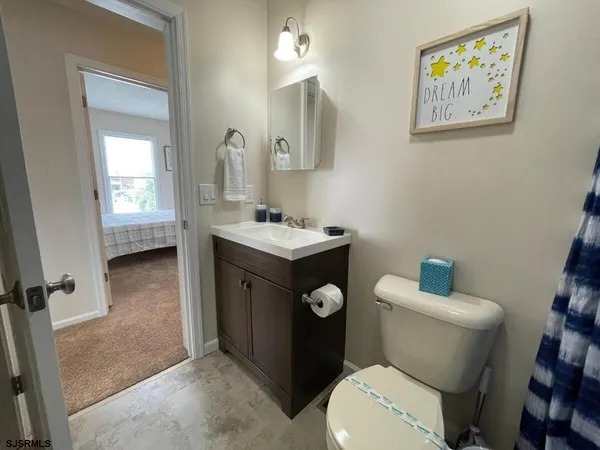 a bathroom with a toilet a sink and mirror