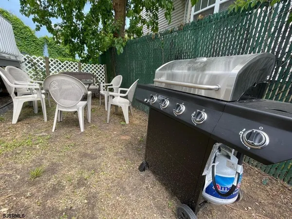 a roof deck with table and chairs