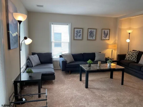 a living room with furniture and a lamp