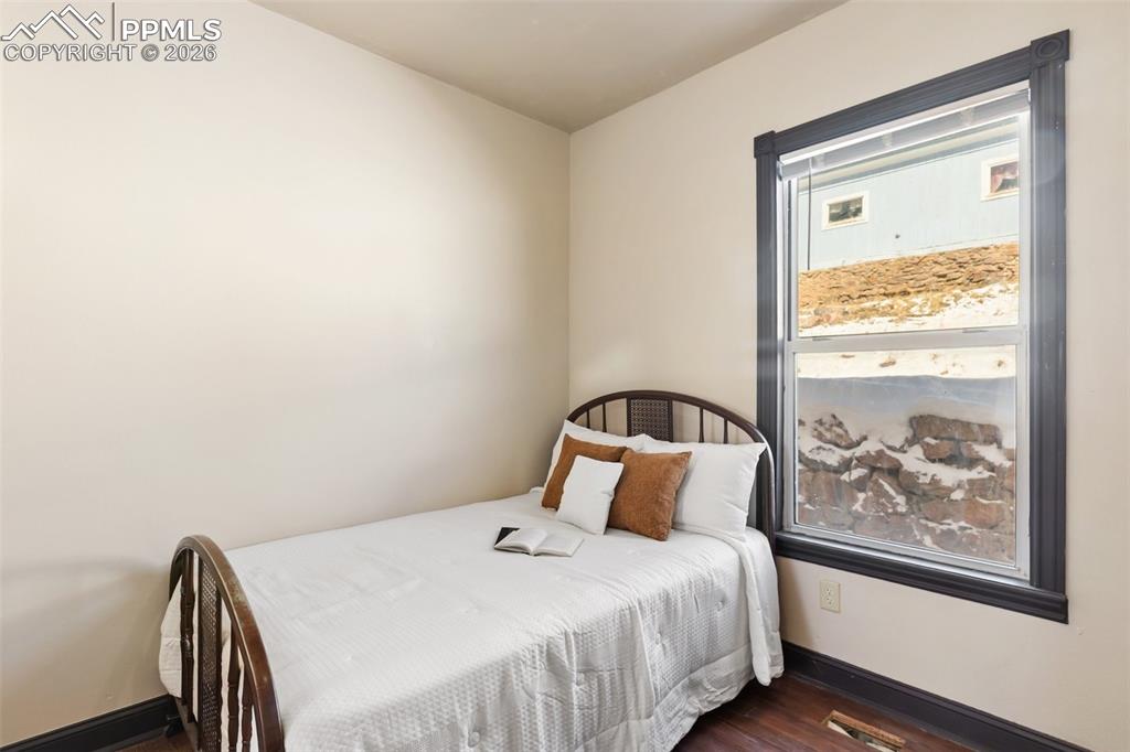 112 6th Street Victor, CO 80860 - Photo 14 of 35 a bedroom with a bed and wooden floor
