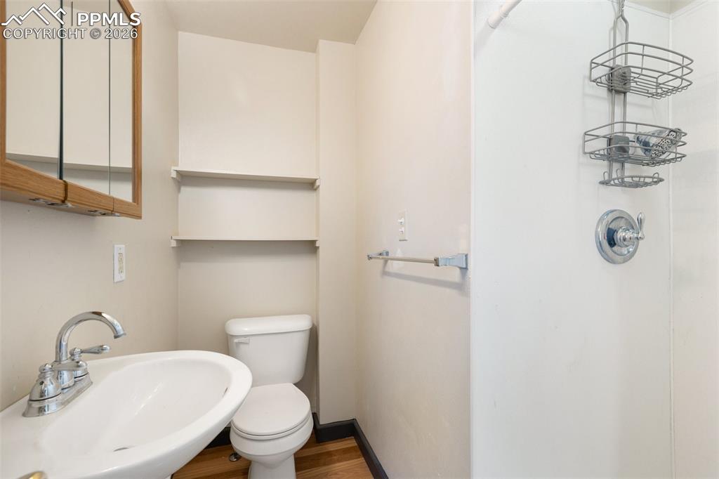 112 6th Street Victor, CO 80860 - Photo 18 of 35 a bathroom with a toilet a sink and mirror
