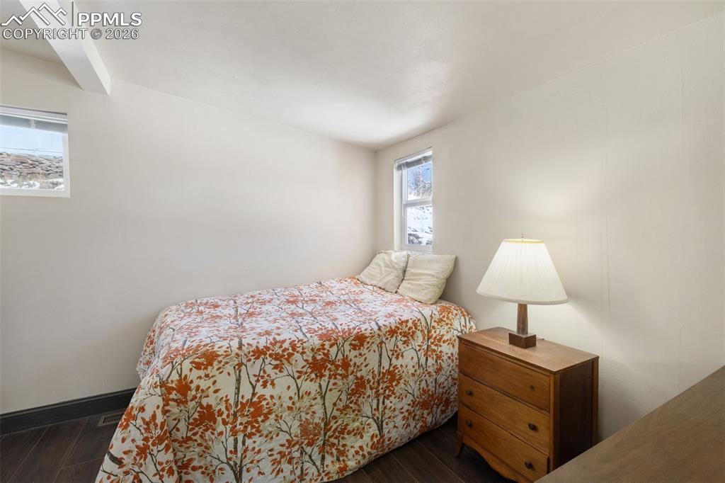 112 6th Street Victor, CO 80860 - Photo 19 of 35 a bedroom with a bed and a lamp