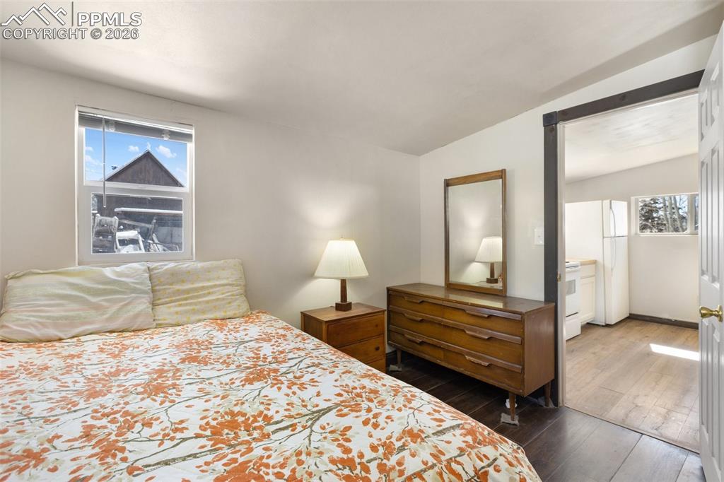 112 6th Street Victor, CO 80860 - Photo 21 of 35 a bedroom with a bed and a painting on the wall